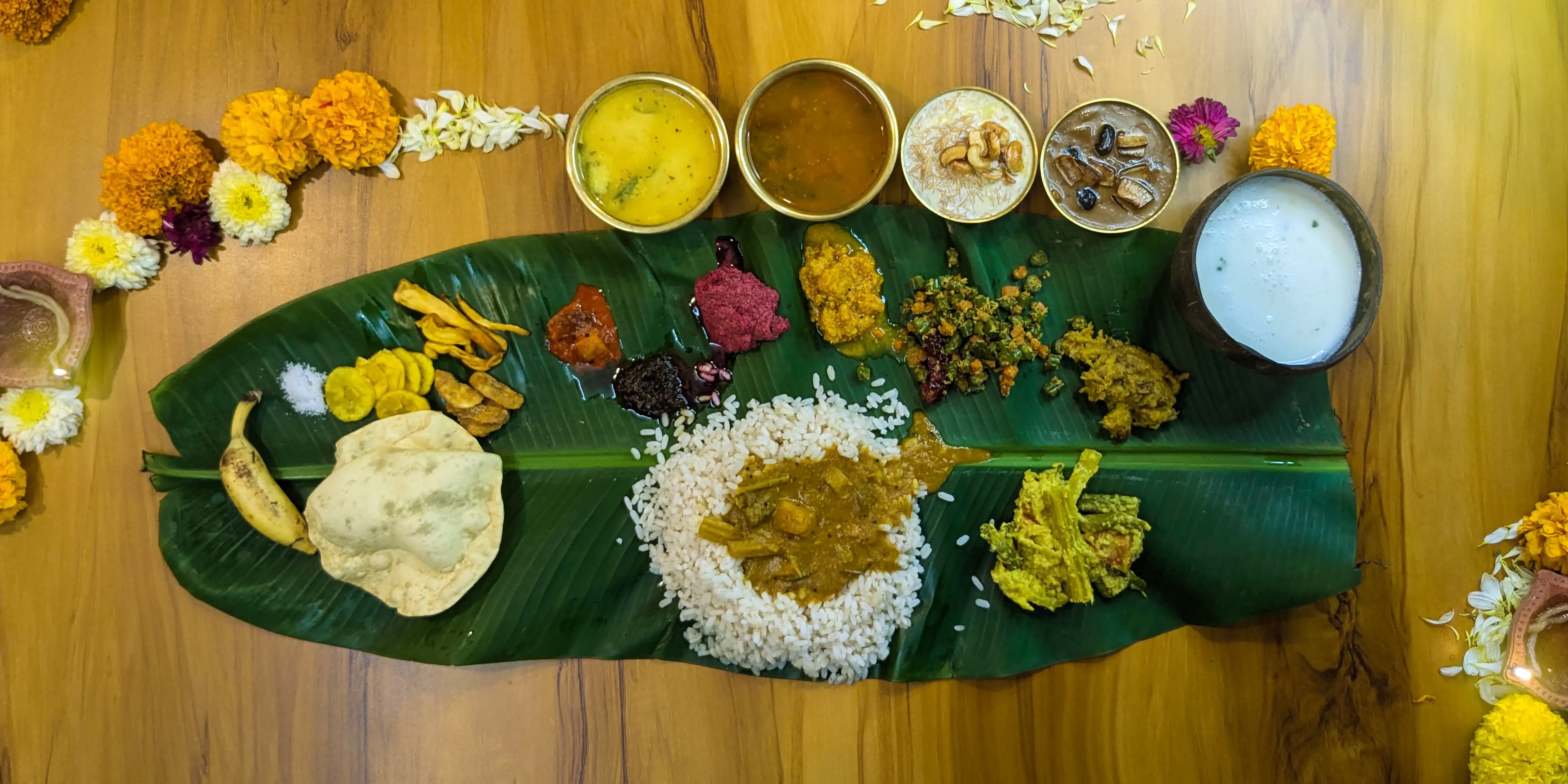 The complete traditional Kerala Onam Sadhya served on a banana leaf at Bhoomi