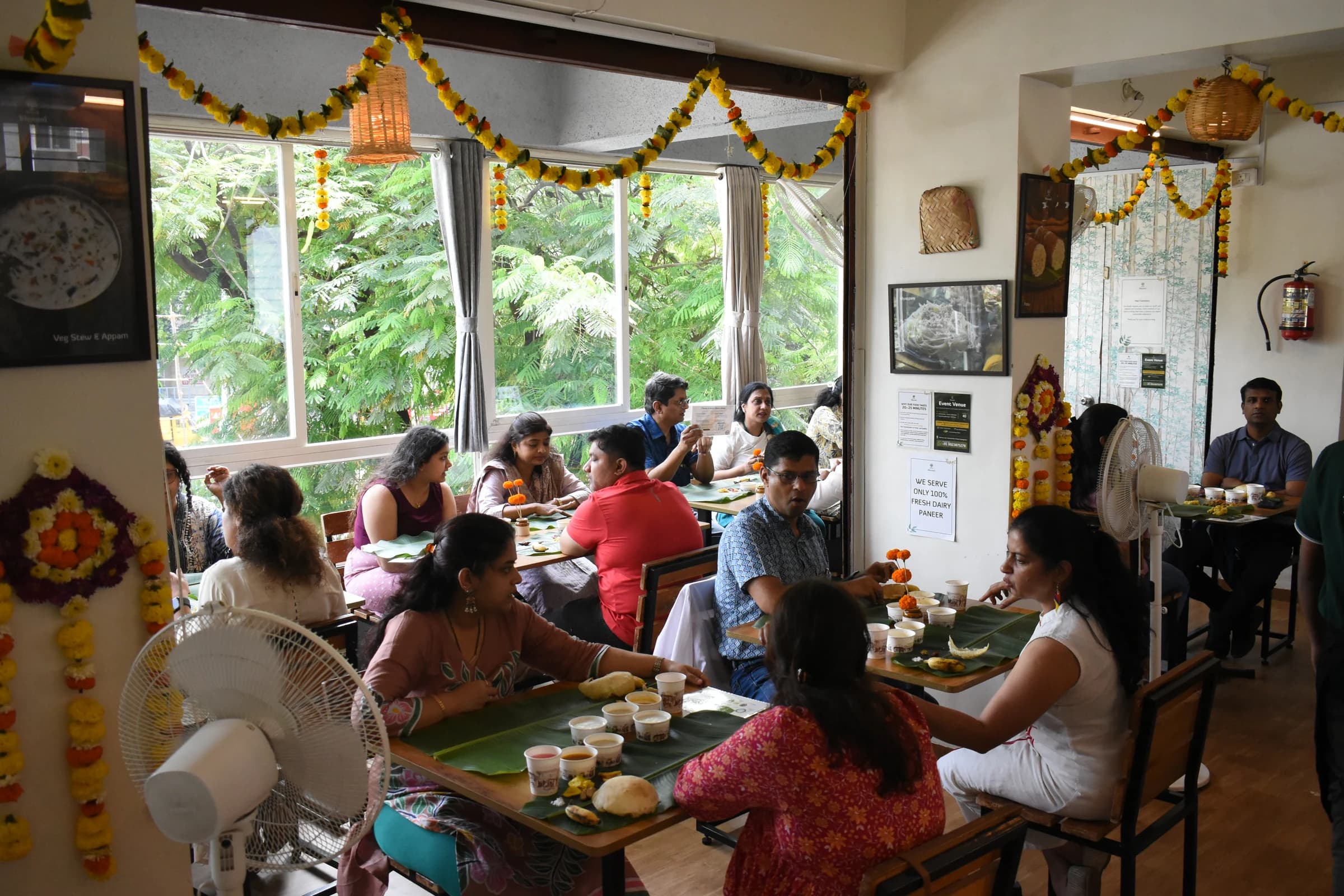 Bhoomi restaurant filled with flowers, banana leaves and guests during Onam Sadhya 2026