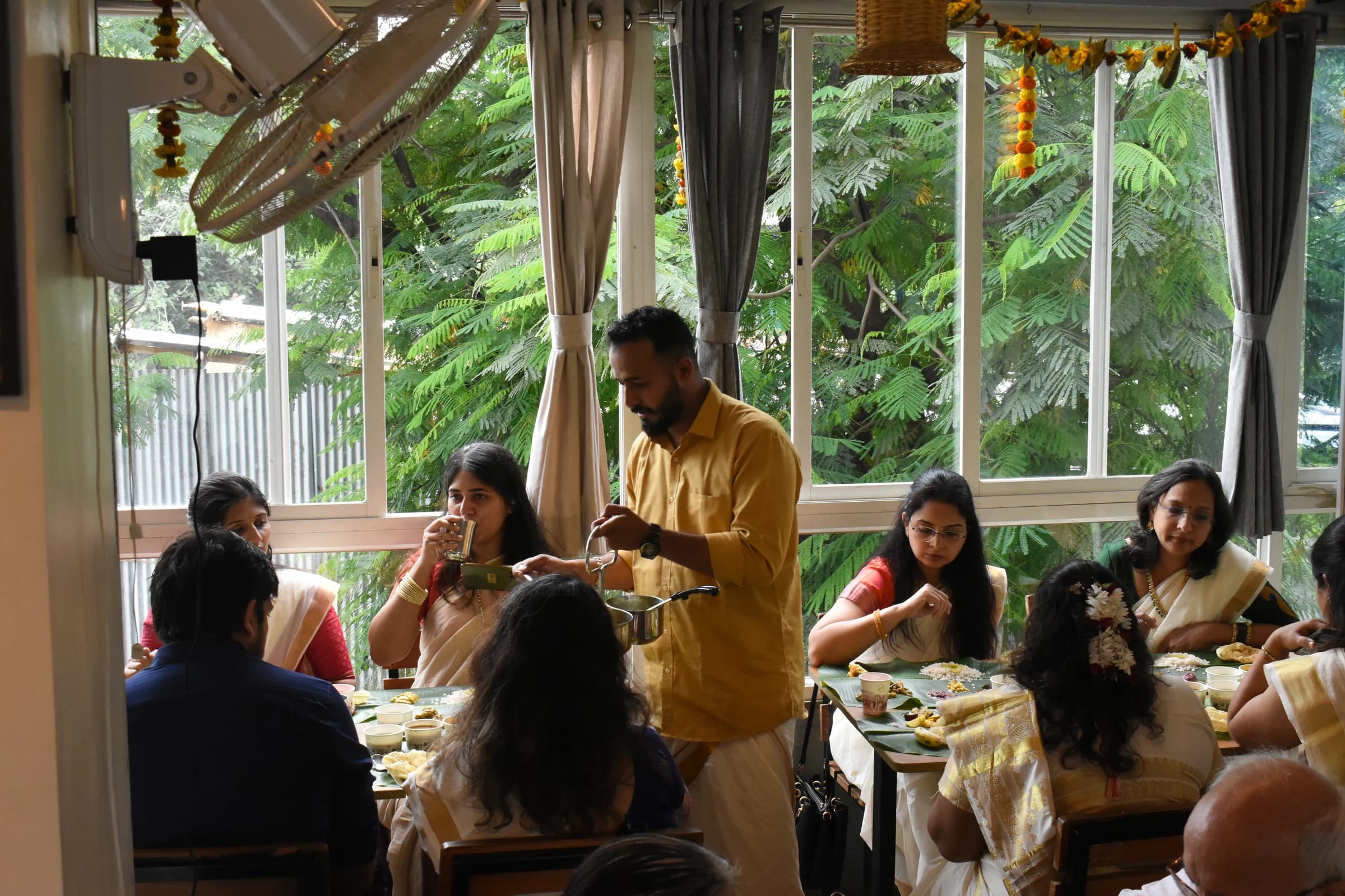 Bhoomi team member serving guests during Onam Sadhya